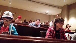 People seated in a lecture hall or classroom.