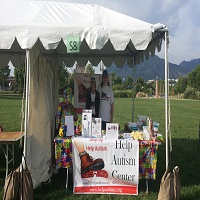 Outdoor booth promoting the Rocky Mountain Arthritis Center with informational materials.