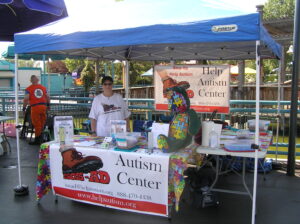 A community outreach table for the Autism Center with informational materials.