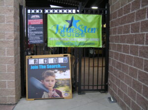 Sign for Yard Star Youth Theater with a child's poster.