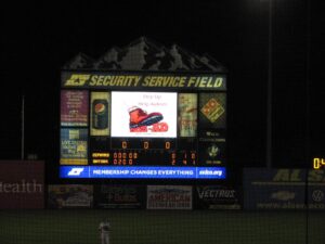 Night view of a baseball scoreboard at Security Service Field.