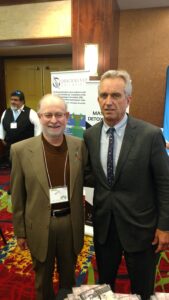 Two men posing together at a conference or event.